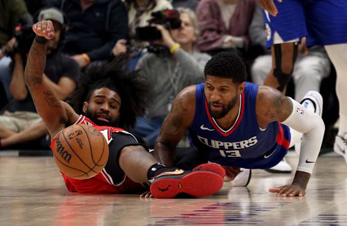 Chicago Bulls guard Coby White (0) and LA Clippers forward Paul George (13) dive for a loose ball during the fourth quarter at Crypto.com Arena.